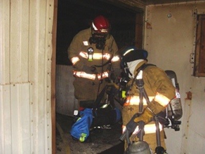 Firemen Coming out of Building